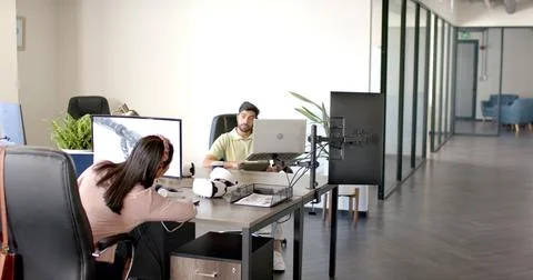 Using VR headsets and computers, colleagues working on robotics project in 스톡 사진
