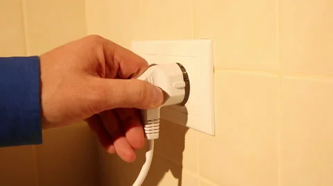 Using a wall electric socket Stock Footage 49997055