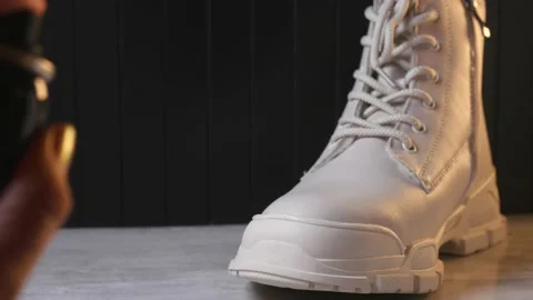 Using waterproof spray for white color winter shoe Stock Footage 162560094