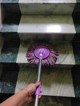 Using of wet mop to clean the floor. Stock Photos