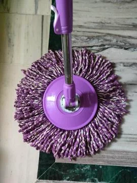 Using of wet mop to clean the floor. Stock Photos