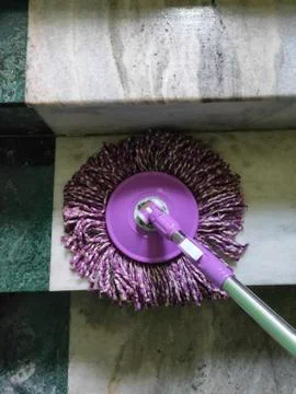 Using of wet mop to clean the floor. Stock Photos