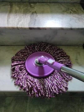 Using of wet mop to clean the floor. Stock Photos