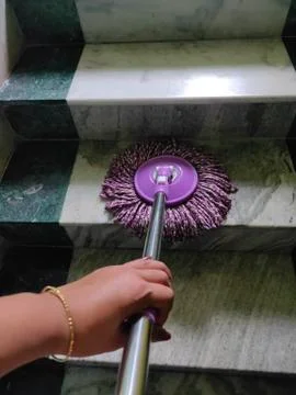 Using of wet mop to clean the floor. Stock Photos