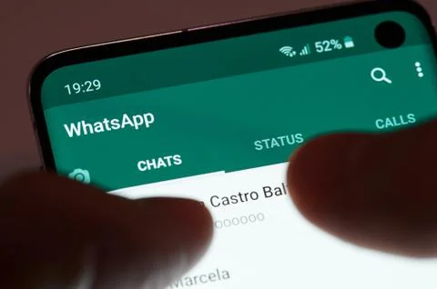Using whatsapp app on smartphone Stock Photos