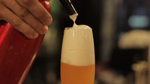 Using Whipping Siphon to Put Ginger Foam on Top Of Cocktail Stock Footage 129780941