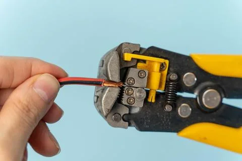 Using wire strippers to prepare electrical wires for connection Stock Photos