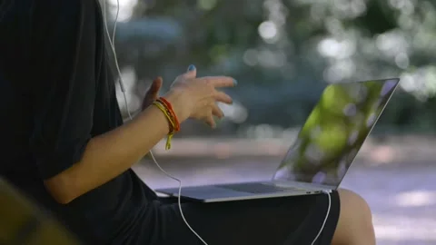 Using wireless device outdoor lady with bracelets and laptop Stock-Footage 157260300