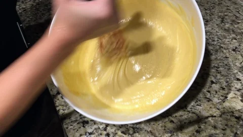 Using a wisk to mix up cake batter Stock Footage 94539501