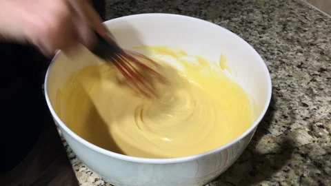 Using a wisk to mix up cake batter Stock Footage 94539667