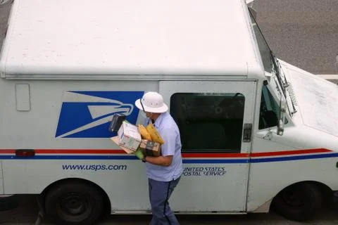 USPS Mailman with Mask and Gloves During the COVID-19 Coronavirus Pandemic Stock Photos