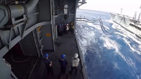 USS Bataan (LHD 5) performs a replenishment-at-sea with USNS Laramie (T-AO 203) Stock Footage 75986933