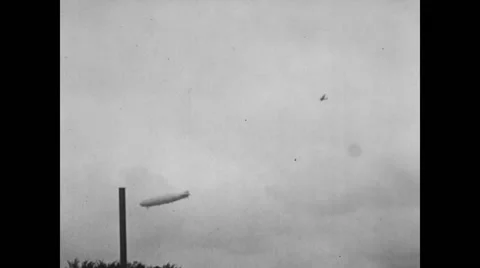 USS Shenandoah airship and airplane flying in sky Stock Footage