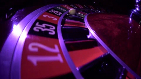 Usual roulette wheel running with fallen white ball, top view. Zero. Close up Stock Footage 68991934