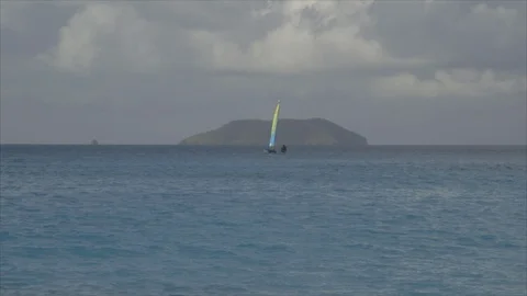 USVI St John Distant Catamaran on Ocean with Island in Background Stock Footage 123667056