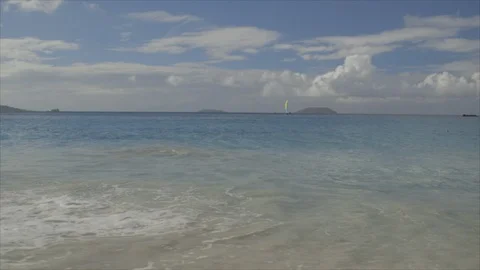 USVI St John Distant Catamaran on Ocean with Waves Rolling into Beach Stock Footage 123667068
