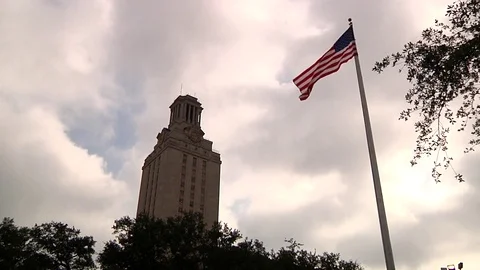 UT Tower and American flag - Austin Texas cam pans and settles Stock Footage 82852890