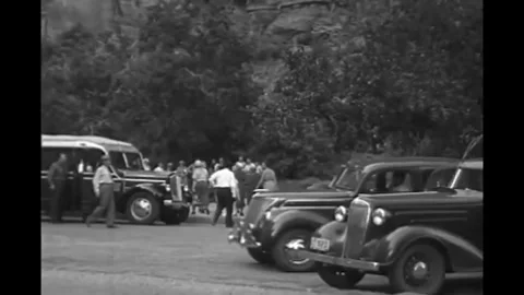 UTAH - 1937 - Groups of tourists getting out of their tour buses and walking Stock Footage 341988064
