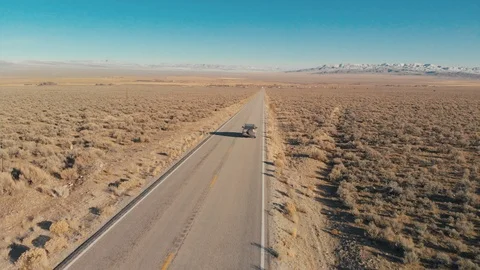 Utah - Aerial shot following silver SUV on rural road Stock Footage 118611053