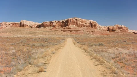 Utah circa-2020.  Stabilized driving shot of gravel road in desert.  Shot with Stock Footage 130358021