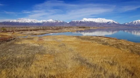 Utah Lake Flyover with Water Reflection and Wasatch Mountains Stock Footage