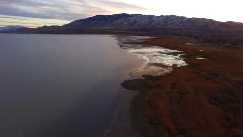 Utah Lake Low Angle with Mountains and Sunset Reveal Vídeos de archivo 70865266