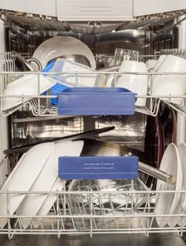 Utensils in dishwasher Stock Photos