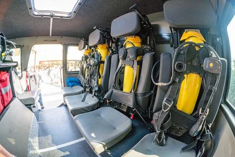 A utilitarian fire truck interior designed for scuba diving, featuring severa Stock Photos