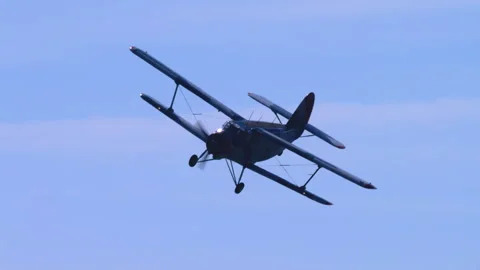 Utility Aeroplane Antonov AN-2 Banking Steeply In Blue Sky Low Angle Tracking Stock Footage 332325134