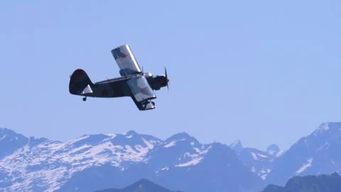 Utility Aeroplane Antonov AN-2 Levelling Off Over Swiss Alps Tracking Shot Stock Footage 332325035