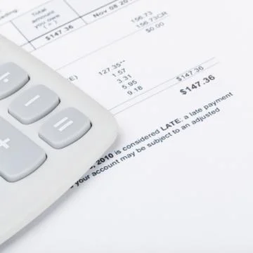 Utility bill with calculator 写真素材
