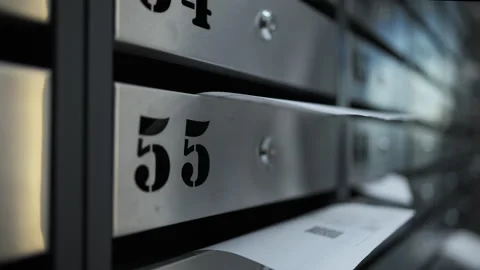 Utility bill partially inserted in apartment mailbox Stock Footage 311278040