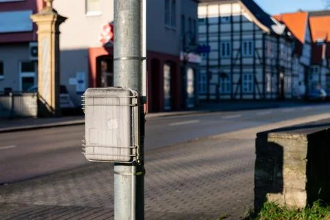 Utility box mounted on pole along a quiet urban street Stock Photos