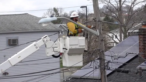 Utility electrical worker uses bucket boom to repair telephone pole wires Video stock 128202640