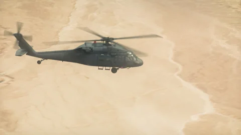 The utility helicopter flies over the desert in strong winds. Stock Footage 331385061