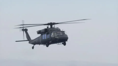 The utility helicopter flies over Rocky And Sandy Areas. Stock Footage 331795404