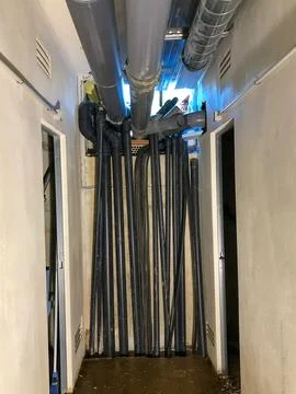 Utility pipes creating abstract lines in narrow urban space 스톡 사진