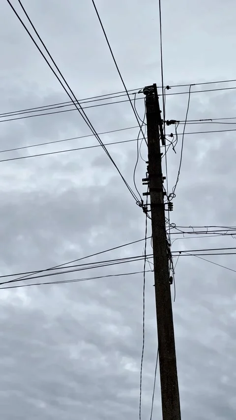 Utility Pole and Overhead Cables Silhouette with Gentle Panning Movement Stock Footage 345718943