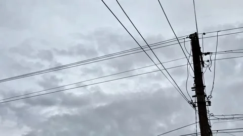 Utility Pole and Overhead Cables Silhouette with Gentle Camera Movement Stock Footage 345718950