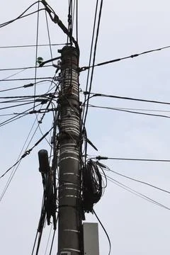 Utility pole with complex messy wiring and cables Stock Photos