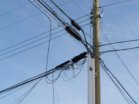 Utility pole confusing power cable phone line mess Stock Photos