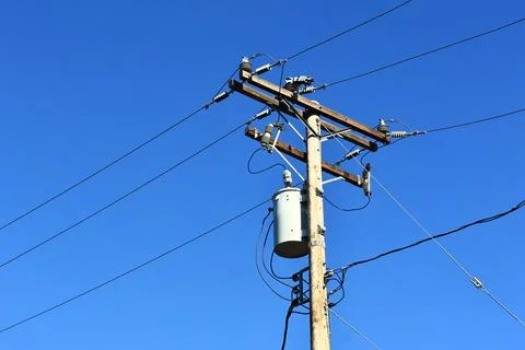 A utility pole with distribution transformers and power lines Stock Photos