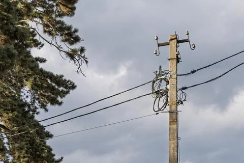 Utility Pole with Electrical and Communication Cables Against Cloudy Sky Fotos de archivo