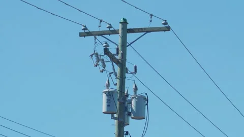 Utility pole with electrical distribution transformers and wires Видео 336348496