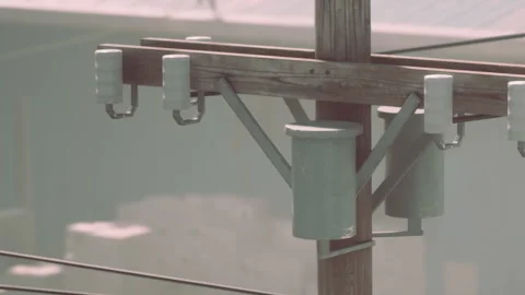 Utility pole with equipment during daylight hours in an urban area Stock Footage 344130081