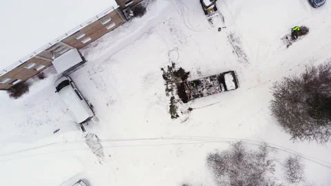 Utility pole hole digging truck working in winter, aerial downwards view Stock Footage 227504892