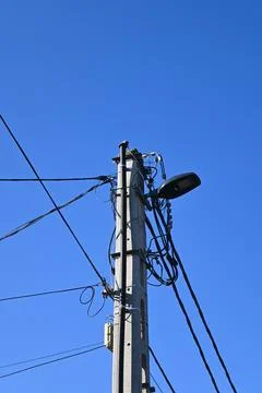 Utility pole with overhead electrical wires and streetlight Stock Photos