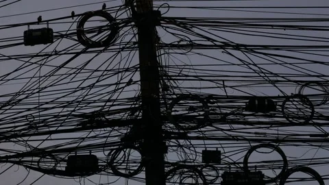 Utility pole overloaded with a dense tangle of electric wires Stock Footage 325478937