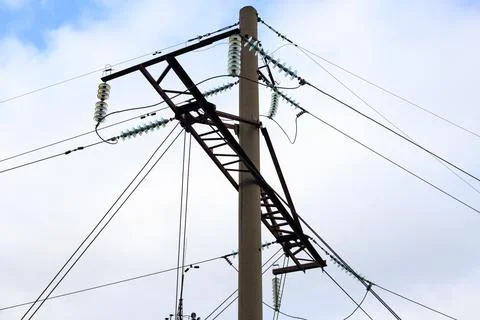 Utility pole with power grid lines and glass insulators, close-up view of e.. Stock Photos