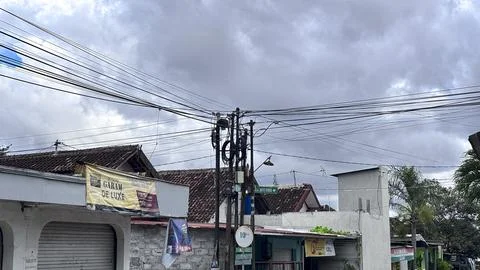 Utility Pole with Power Lines Under Cloudy Sky Stock Photos